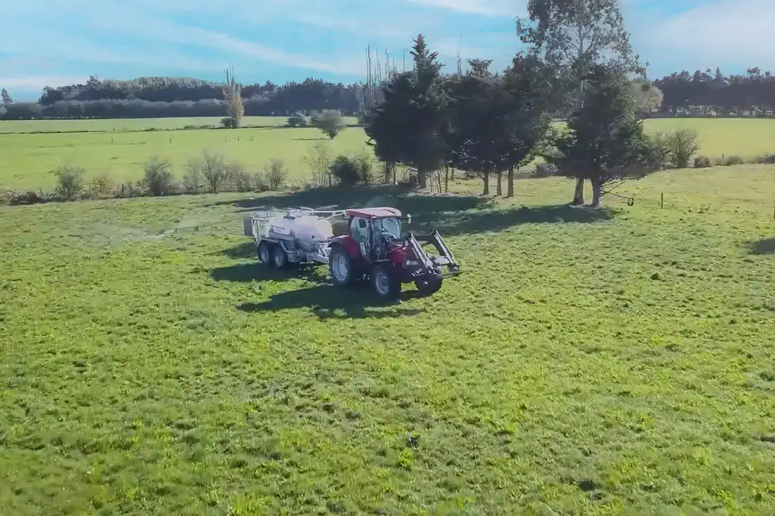 Aerial view of a tractor towing a Tow and Fert Multi 4000 across a paddock at Amy Stokes's farm near Christchurch