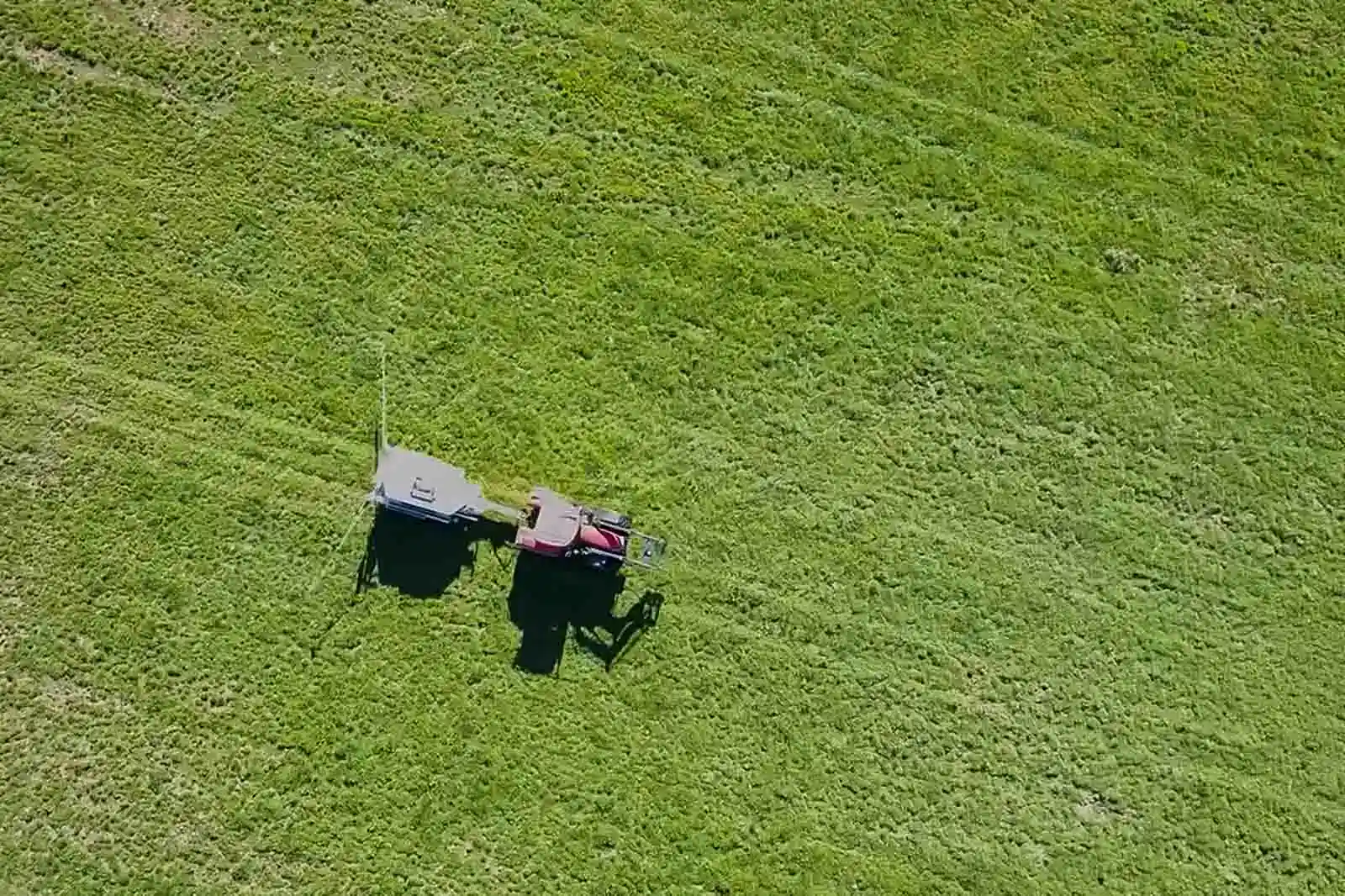 Aerial view of a tractor towing a Tow and Fert Multi 4000 across pasture