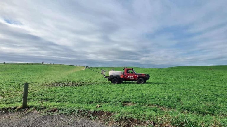 Tow and Fert Multi 1000 ute-mounted unit applying product across a green pasture.